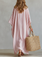 Soft pink striped kaftan dress with loose silhouette and wide draped sleeves, back view