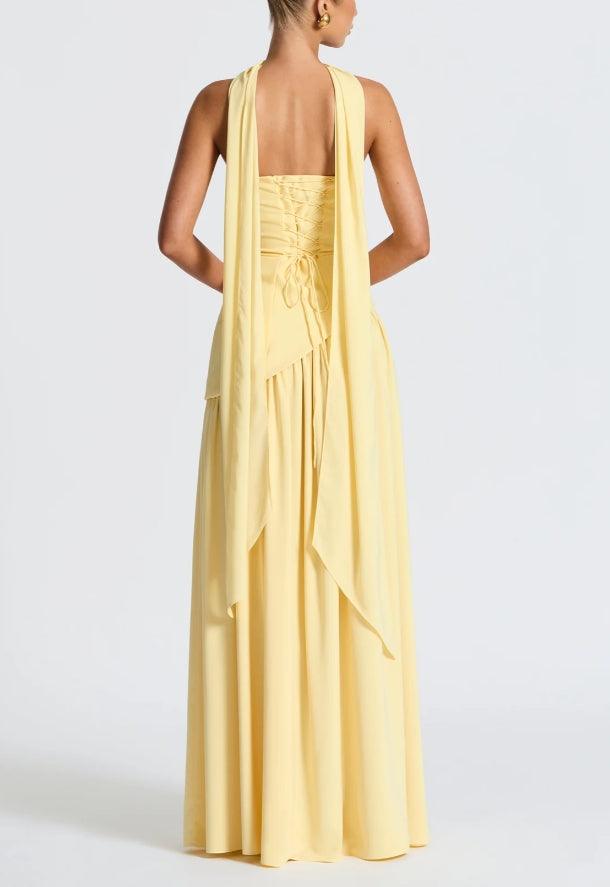 Back view of strapless yellow maxi dress with draped tier detail