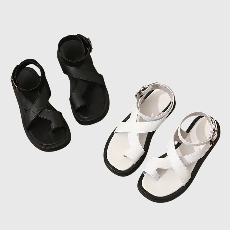Orthopedic sandals in black and white, each with an ankle buckle