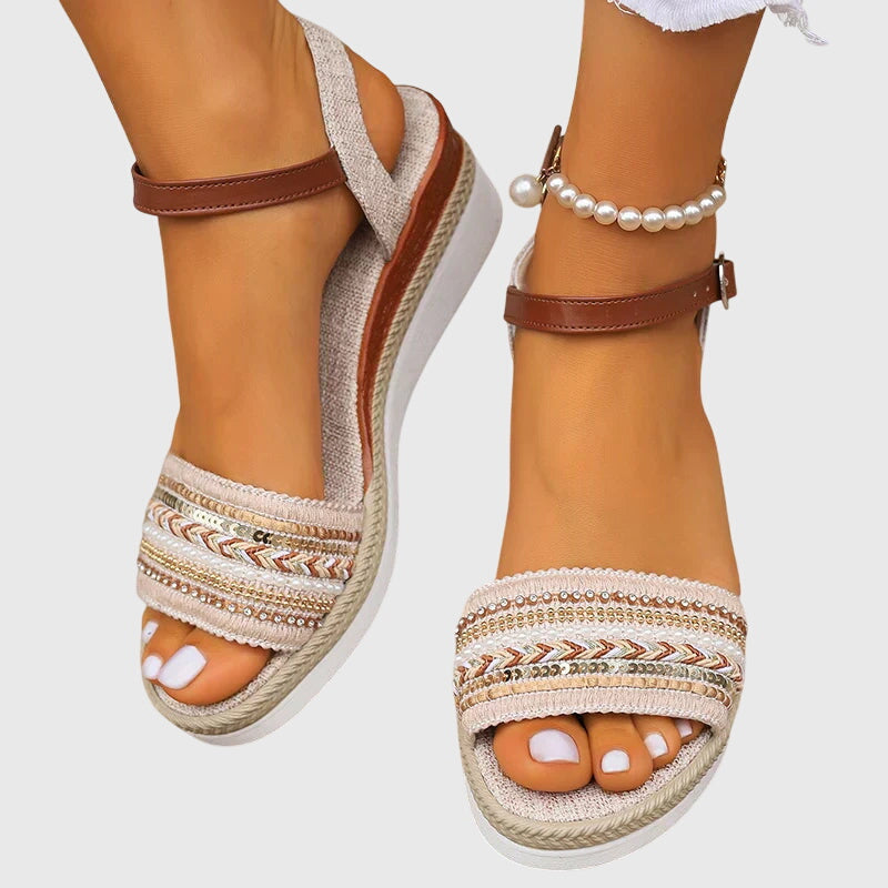 Pair of white and brown open-toe platform sandals with ankle strap and woven trim