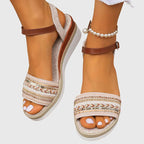 Pair of white and brown open-toe platform sandals with ankle strap and woven trim