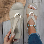 Beige flat sandals with mesh strap and round metal buckle