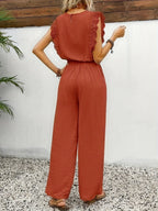 Rust red sleeveless two-piece set with tied waist and wide-leg wide trousers