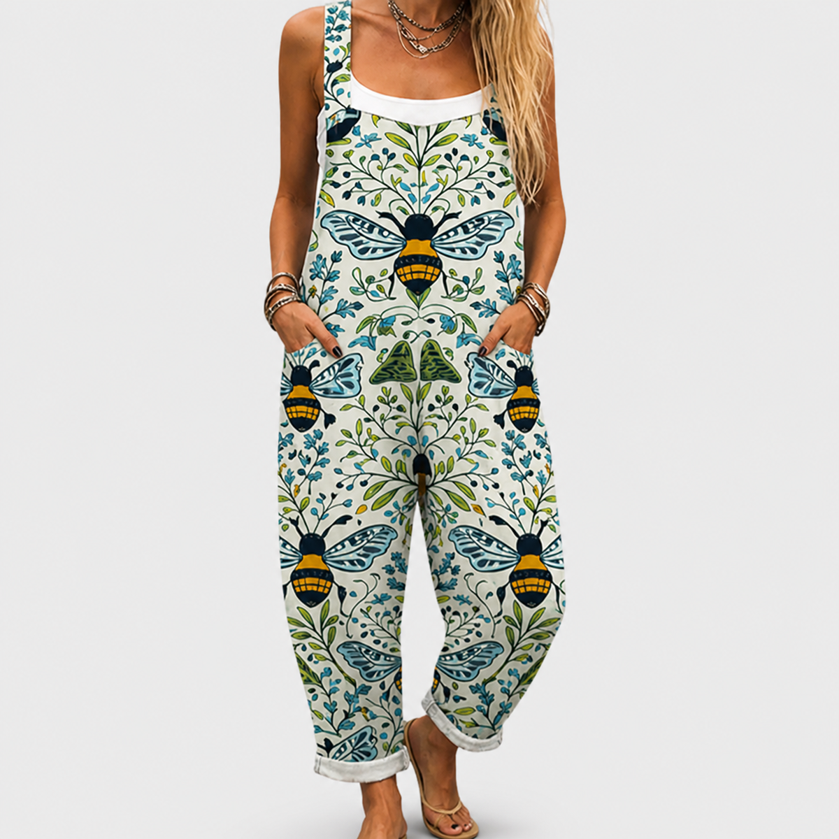Printed overalls with blue butterfly and leaf print, sleeveless bib front, loose legs