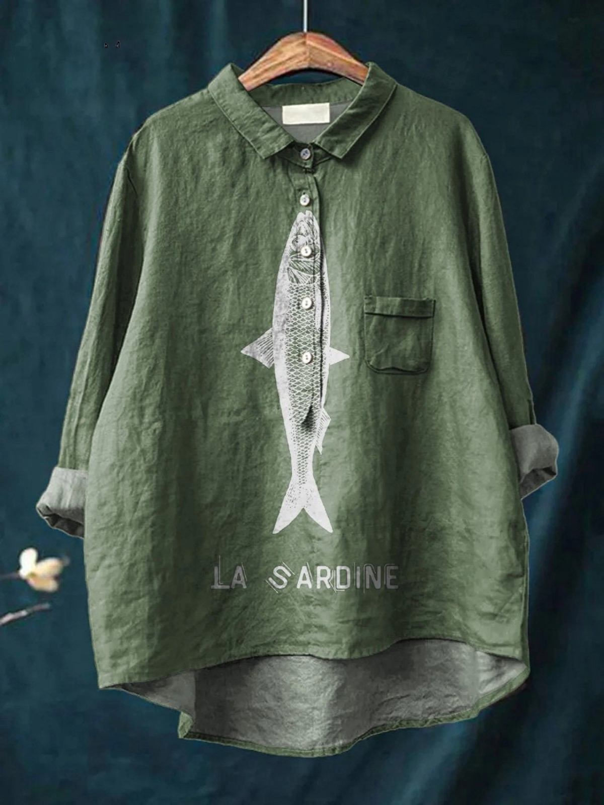 Green women's casual button-up shirt with sardine graphic and chest pocket.