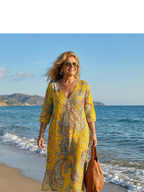 Yellow paisley midi dress with V-neck and three-quarter sleeves, side profile
