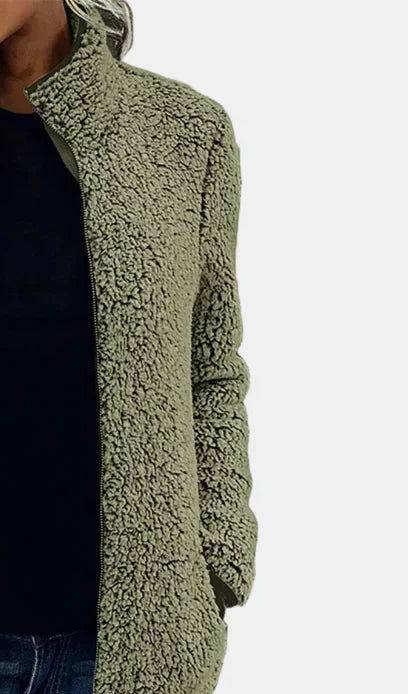 Green teddy jacket close-up with full-zip front and textured fleece fabric.