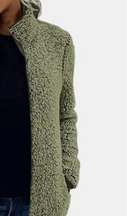Green teddy jacket close-up with full-zip front and textured fleece fabric.
