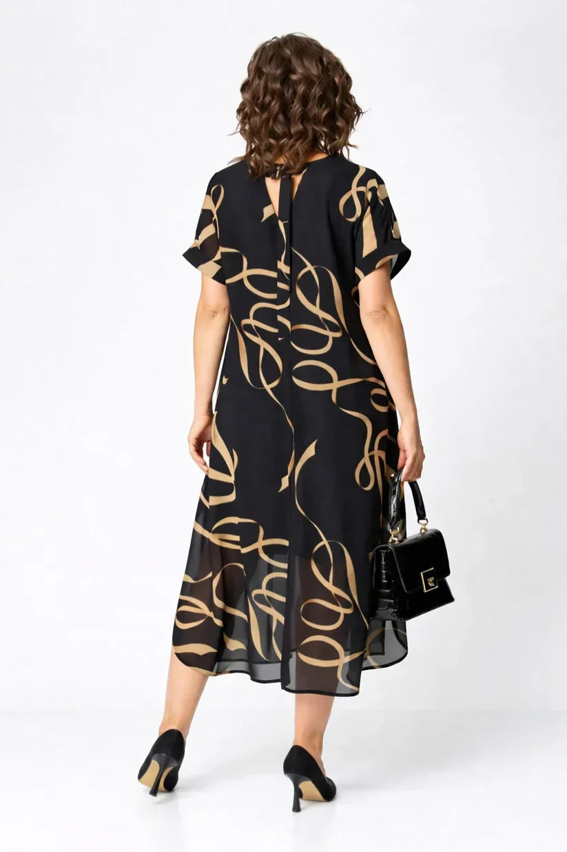 Women's black midi dress back view with gold swirl print, short sleeves, open-back tie
