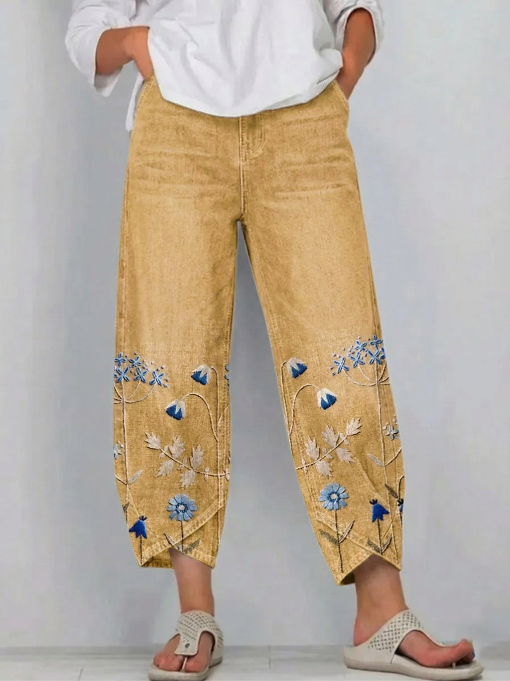 Yellow casual trousers with blue-and-white floral embroidery panels on the sides