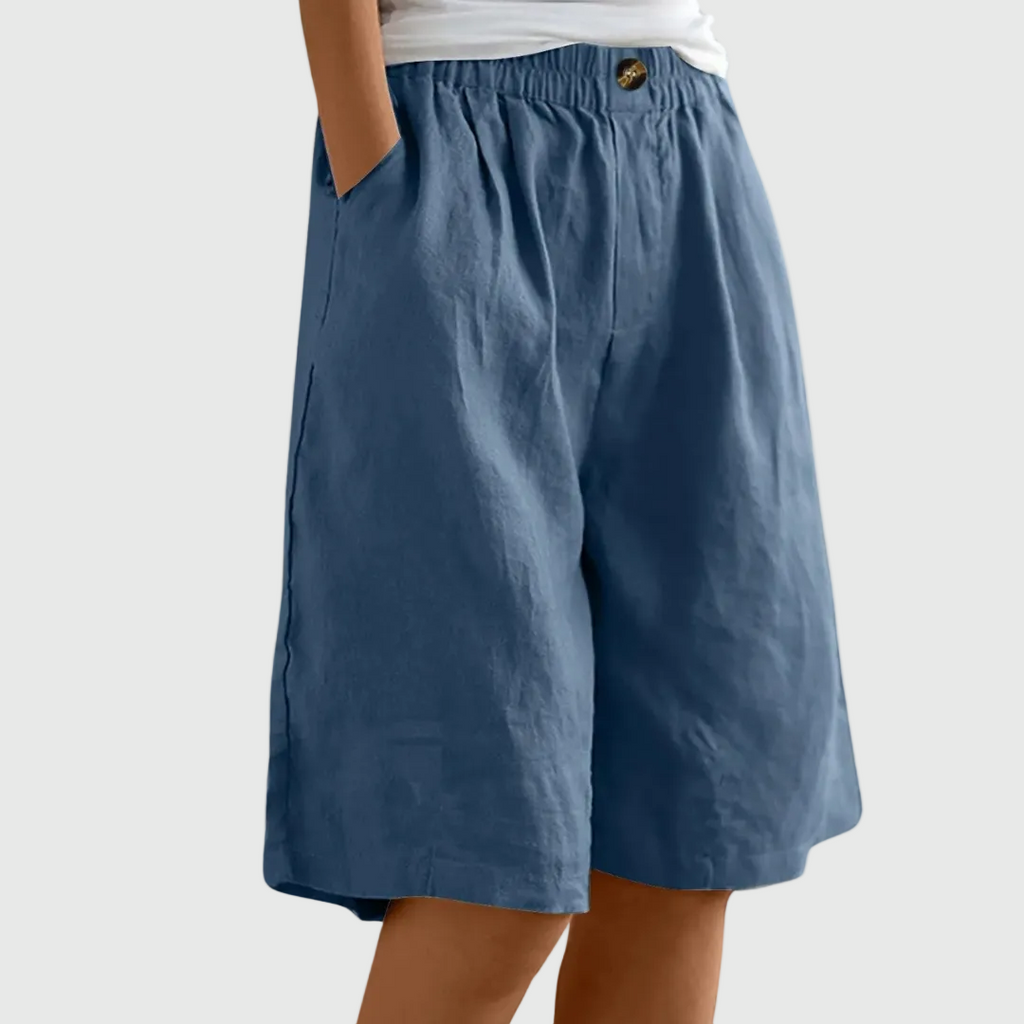 Loose-fit elastic waist shorts in medium blue with button detail at waistband