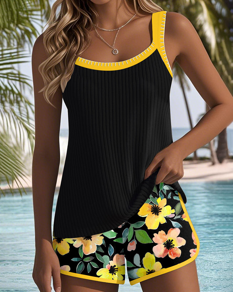 Two-piece beach tankini with black ribbed tank and yellow trim, floral shorts