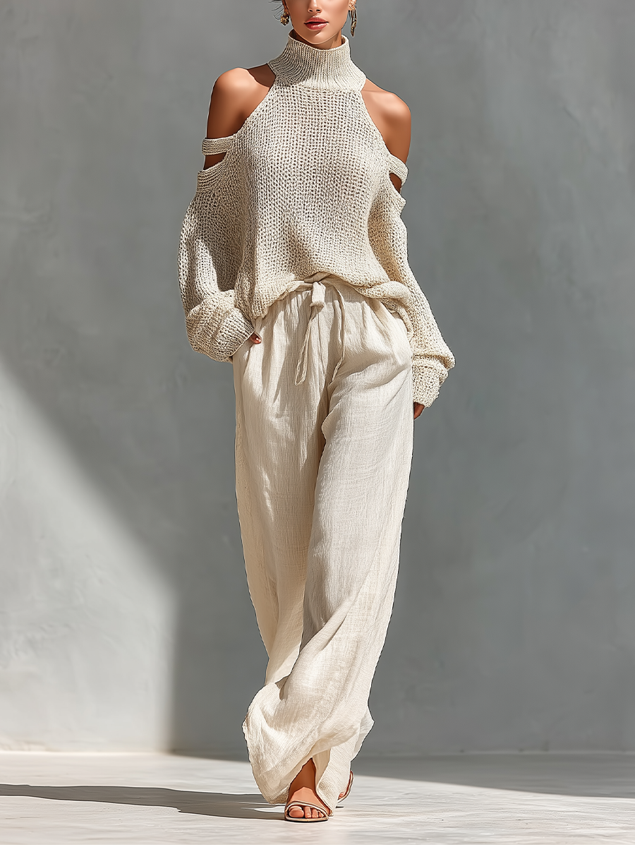 Cream knit cold-shoulder turtleneck top with long sleeves and tie-waist wide-leg pants.