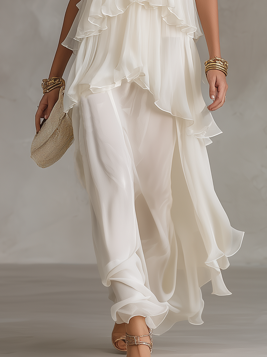 White sheer tiered chiffon maxi skirt with flowing ruffle tiers and draped hem