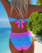 Leopard-print bikini from behind with center bow at mid-back and matching high-cut bottoms