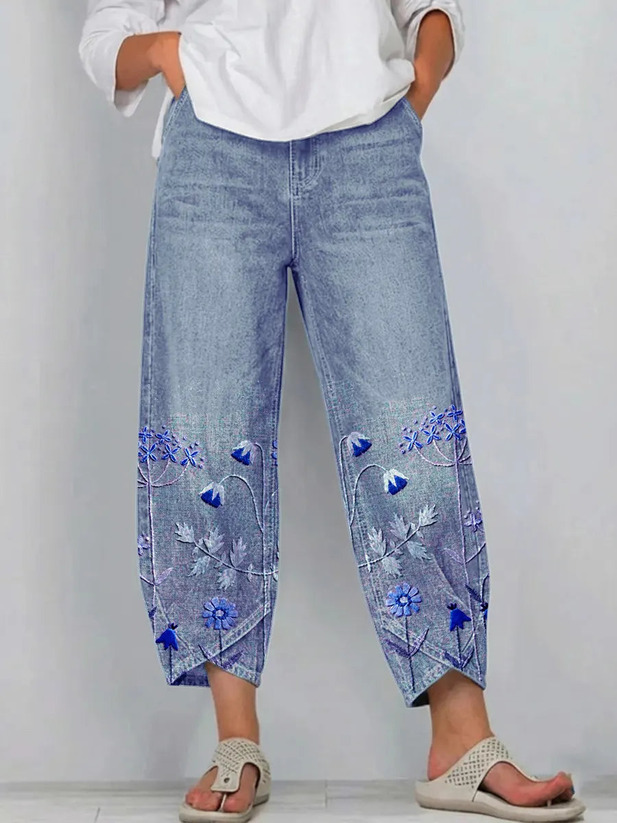 Blue casual trousers with blue-and-white floral embroidery panels on the sides