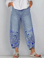 Blue casual trousers with blue-and-white floral embroidery panels on the sides