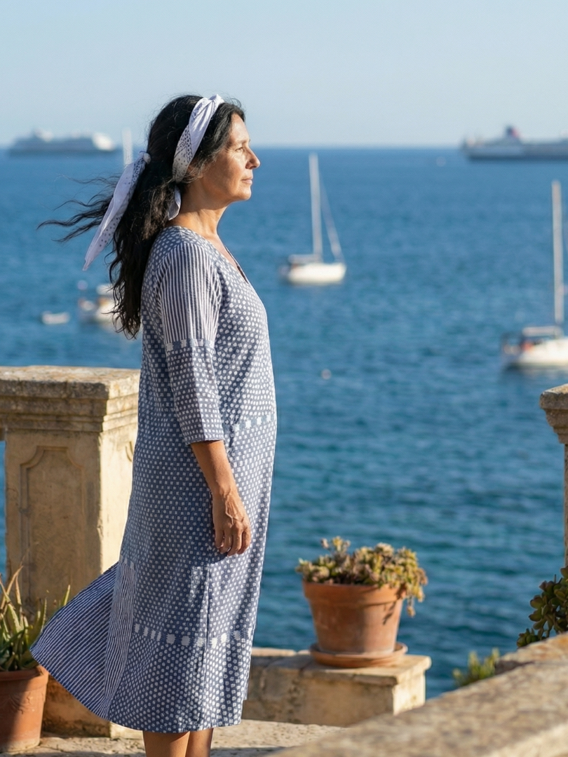 Blue patchwork midi dress side profile, V-neck and dot-and-stripe panel details