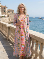 Floral midi dress on outdoor railing, V-neck with multicolor pink and blue blooms