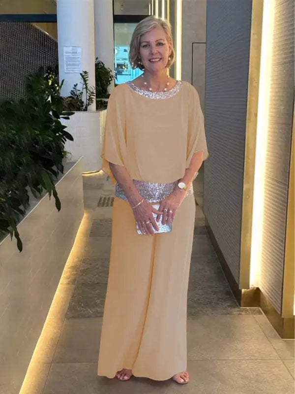 Beige 2-piece set with draped cape top, wide-leg pants, and sequin waist belt