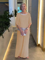 Beige 2-piece set with draped cape top, wide-leg pants, and sequin waist belt