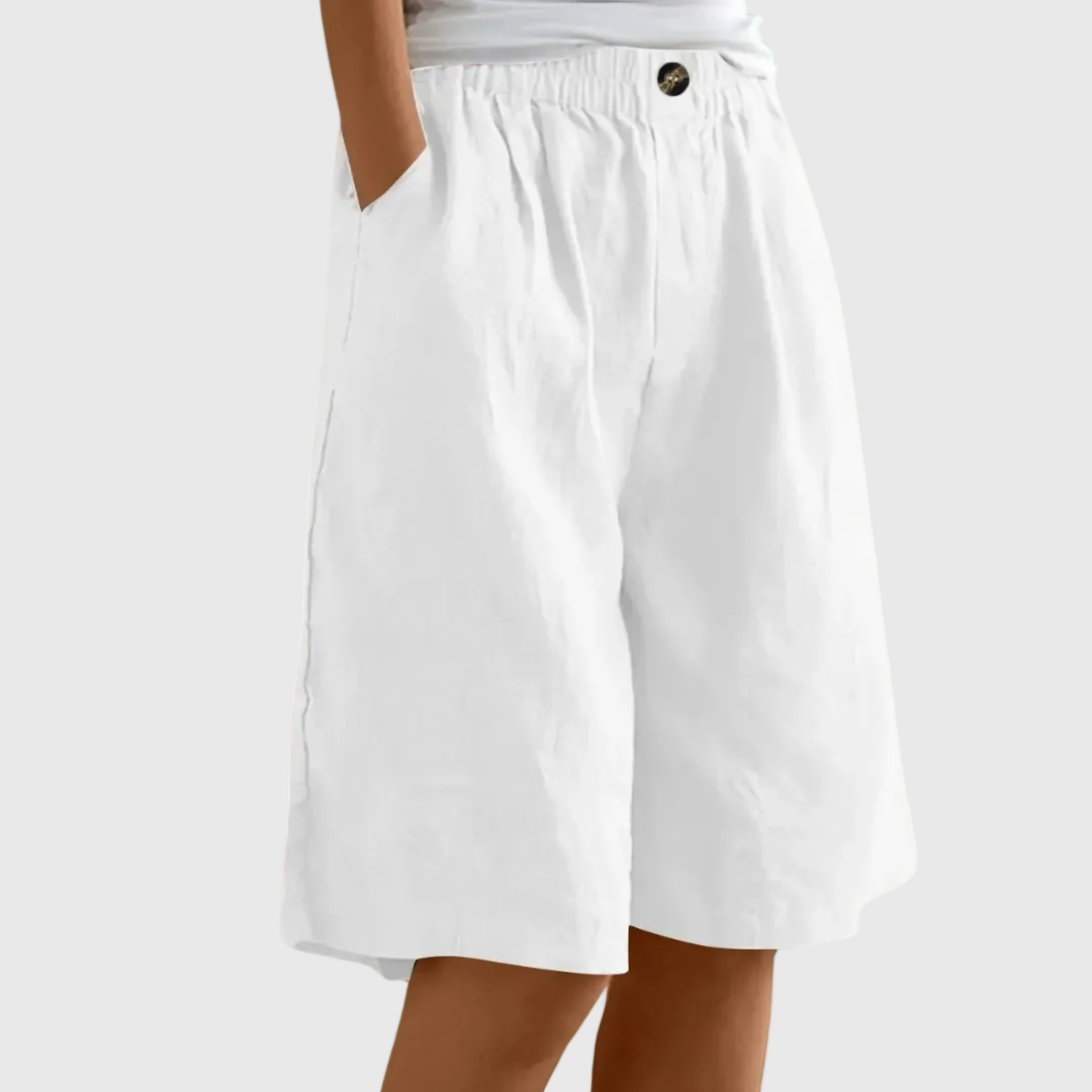 Loose-fit elastic waist shorts in white with button detail at waistband