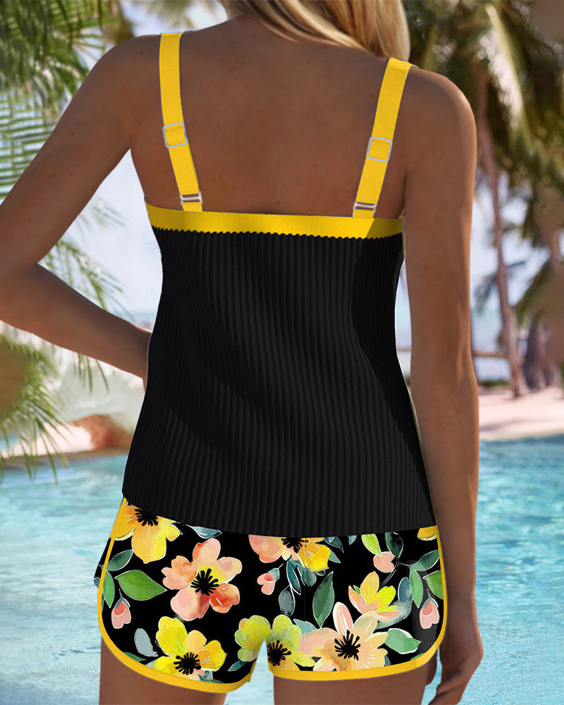 Two-piece beach tankini with black ribbed tank and yellow-trimmed floral shorts