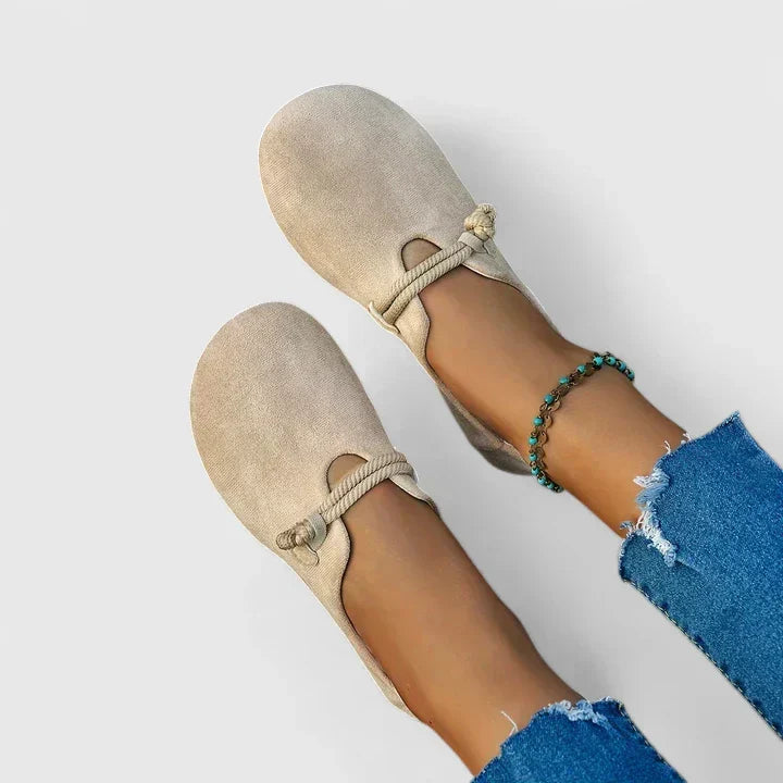 Beige suede slip-on loafers with braided tie strap