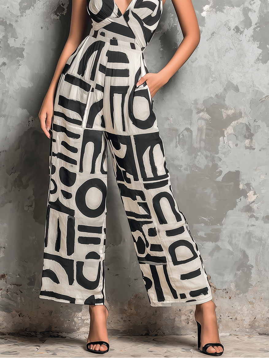 Women's wide-leg jumpsuit with V-neck front and abstract geometric black-and-white pattern.