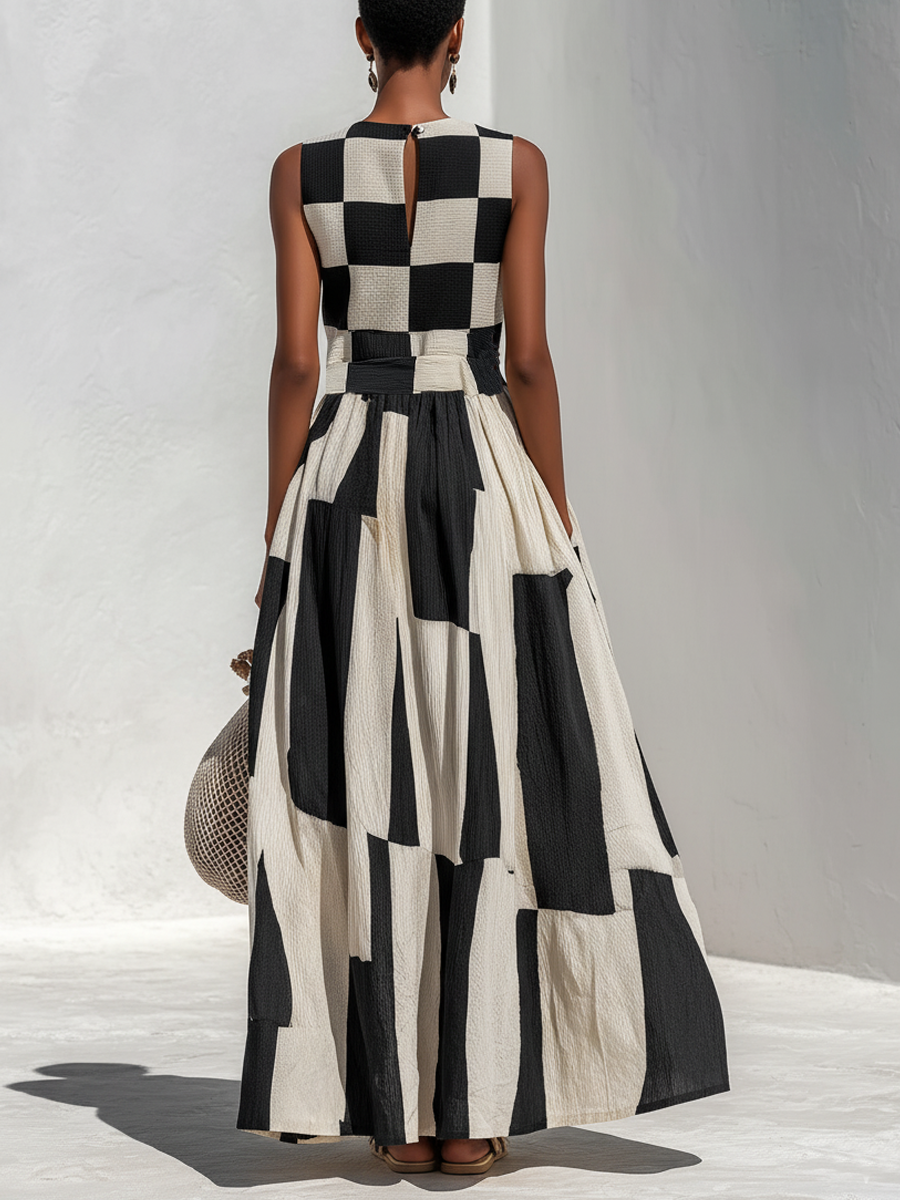 Back view of black and white check-and-stripe sleeveless maxi dress with waist ruching