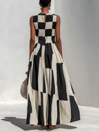Back view of black and white check-and-stripe sleeveless maxi dress with waist ruching