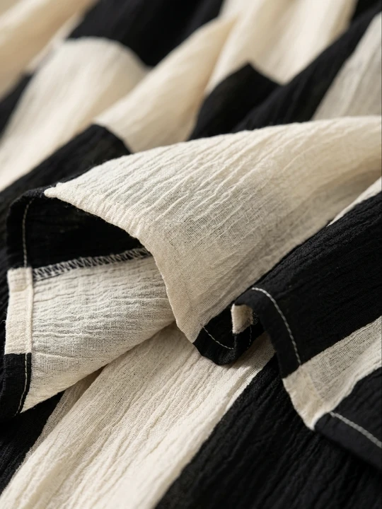 Close-up of black and white check-and-stripe fabric with soft crinkle texture
