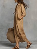 Beige button-front casual dress with chest pockets and cuffed sleeves, side walk view