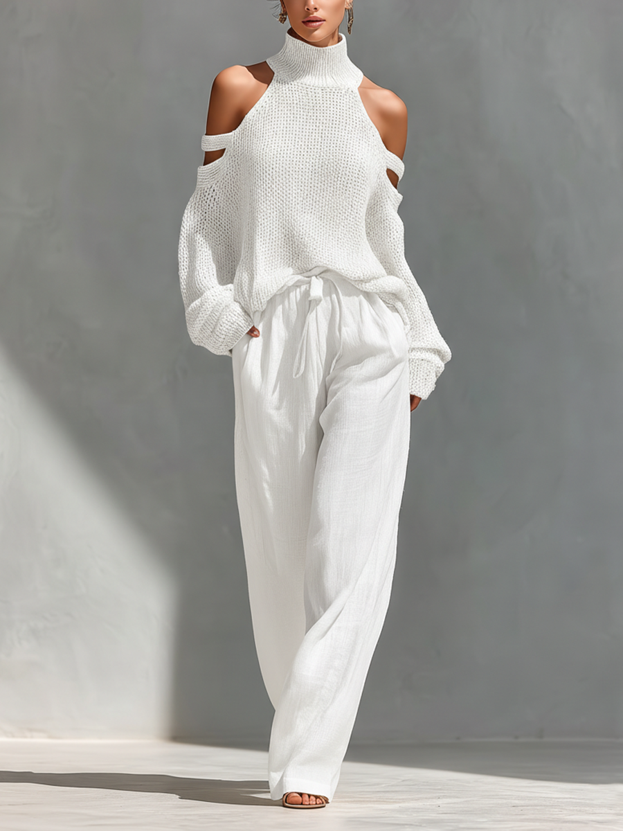 Cream knit cold-shoulder turtleneck top with off-shoulder cutouts and tie-waist wide-leg pants.