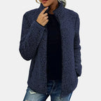 Navy teddy jacket with full-zip front and stand collar, worn over dark top.