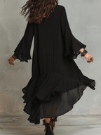 Black boho midi dress from back view with tiered ruffle hem and flowing flared sleeves