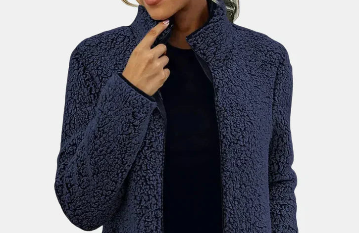 Navy teddy jacket close-up with full-zip front and textured fleece fabric.