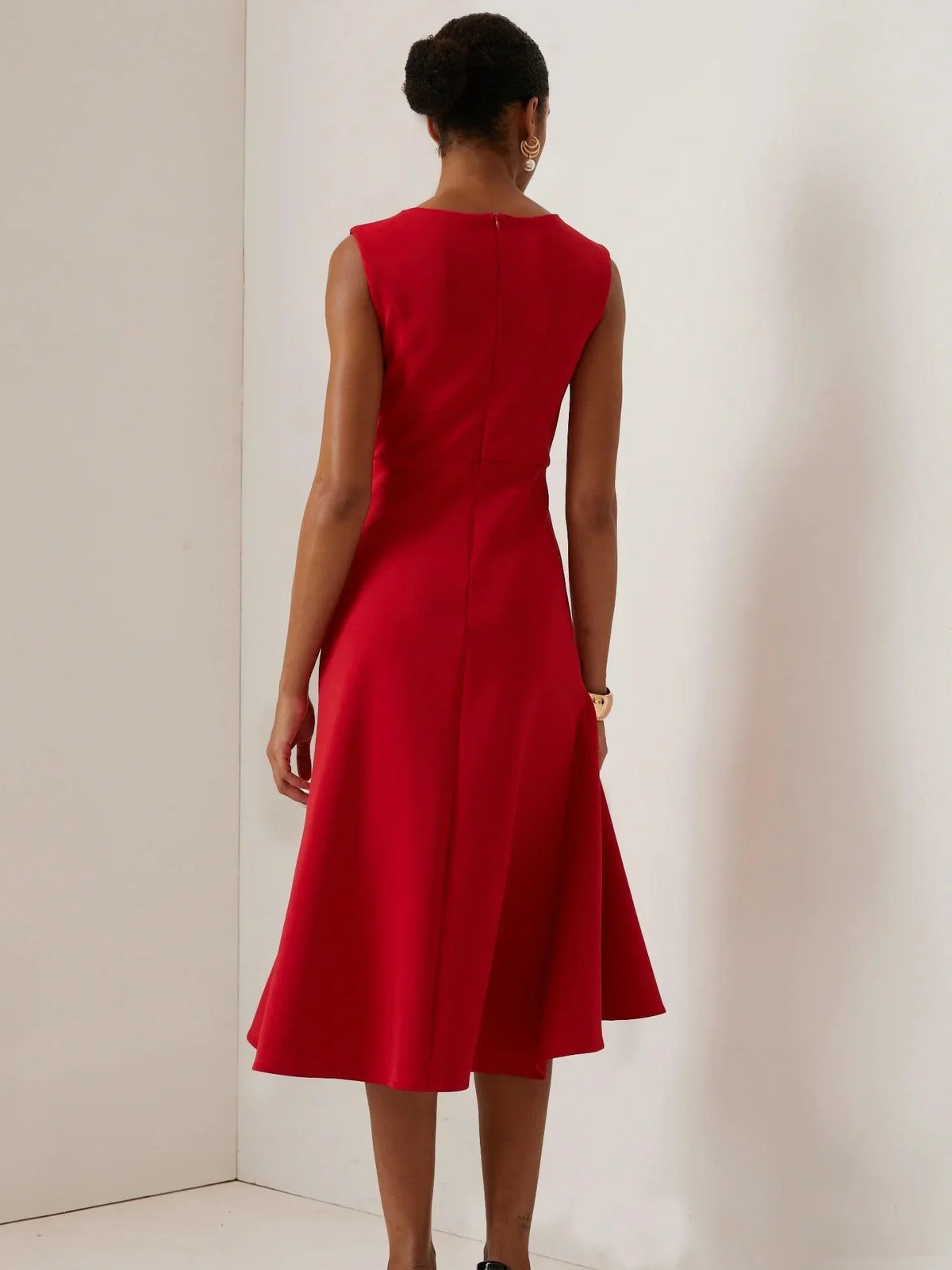 Back view sleeveless red midi A-line dress with waist drape and flared hem