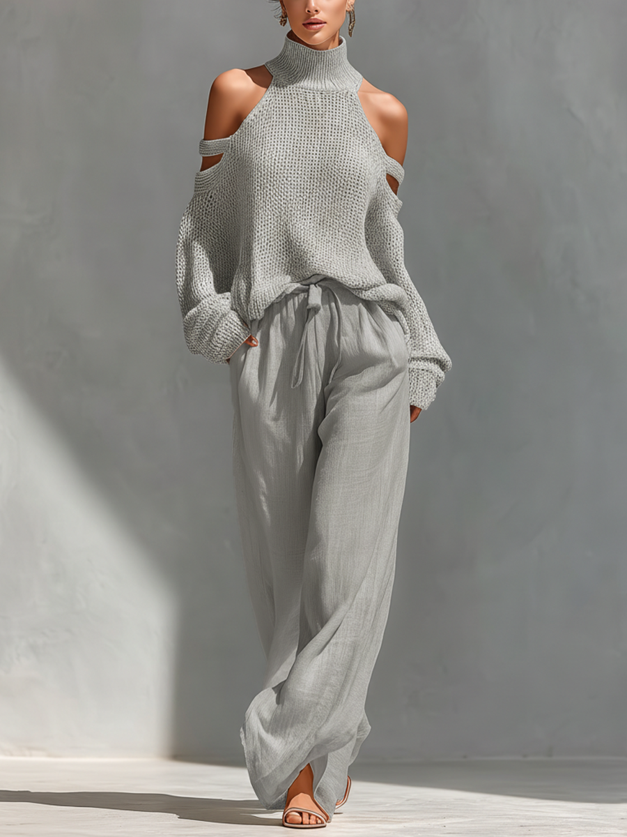 Cream knit cold-shoulder turtleneck top with long sleeves and tie-waist wide-leg pants.