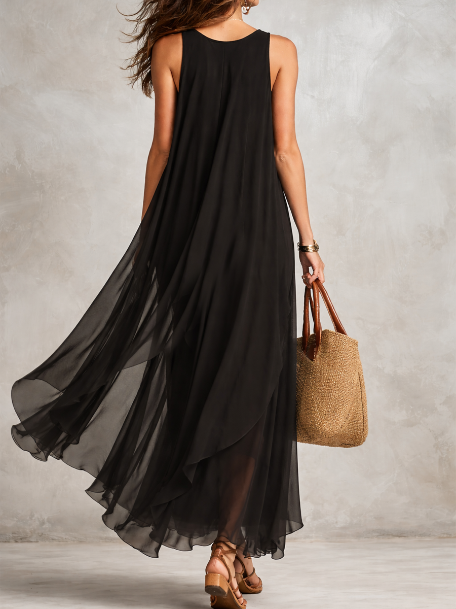Black sleeveless layered chiffon maxi dress, flowing tiered skirt, back view