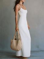 White strappy maxi dress with side slit, sleeveless fitted bodice, hand-bag carry