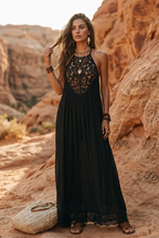 Black sleeveless maxi dress with lace halter panel and long tiered drape