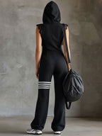 Black hooded back view jumpsuit with striped leg bands and lace shoulder trim