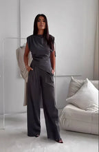Dark gray sleeveless top with draped waist and wide-leg pants two-piece set