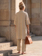 Elegant set with long short-sleeve shirt and wide-leg pants, light tan color