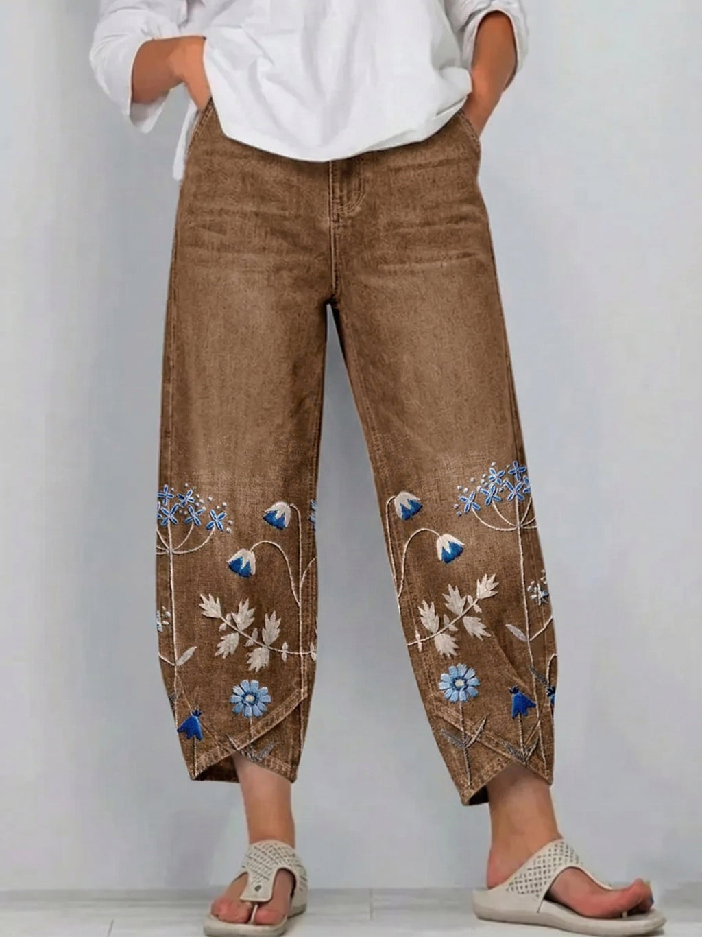 Brown casual trousers with blue-and-white floral embroidery panels on the sides