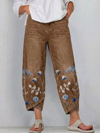 Brown casual trousers with blue-and-white floral embroidery panels on the sides