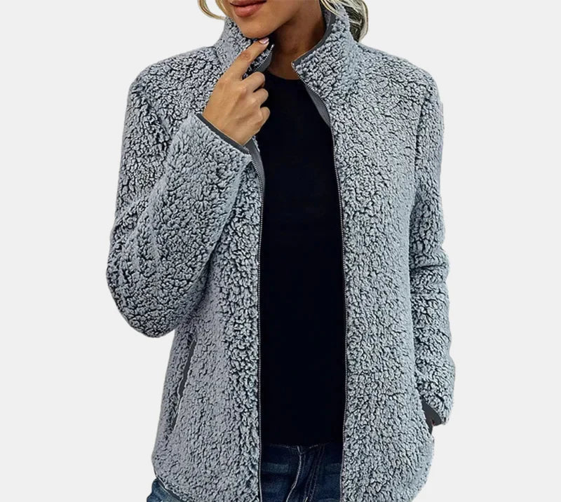 Grey teddy jacket worn open over dark top, zip-front, textured fleece