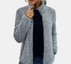 Grey teddy jacket worn open over dark top, zip-front, textured fleece