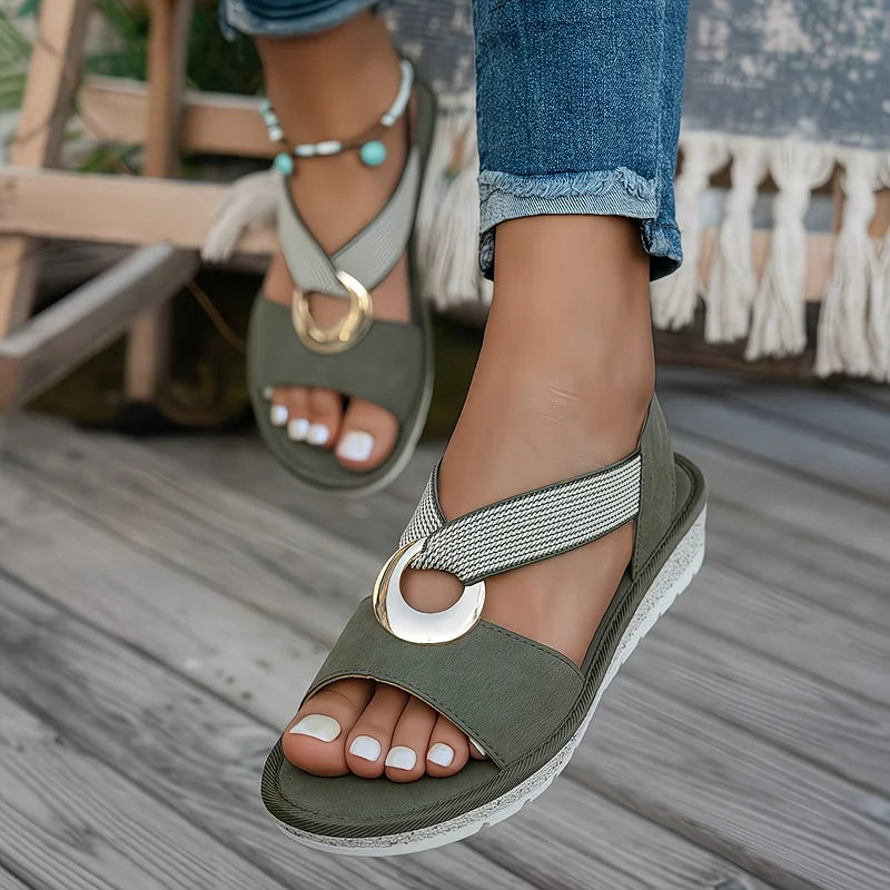 Green flat sandals with wide strap and round metal buckle